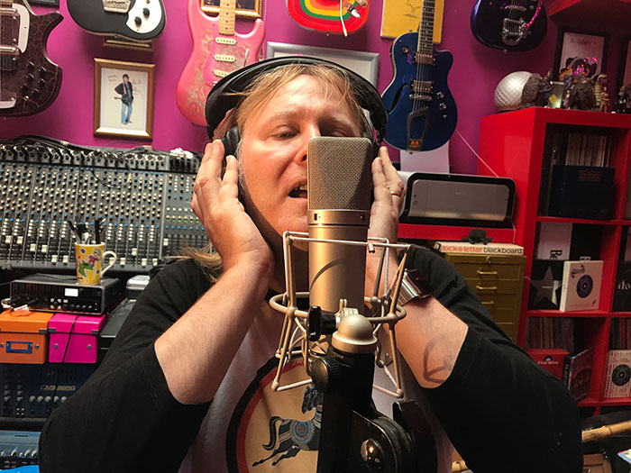 Music composer for hire David Fisher singing in the studio